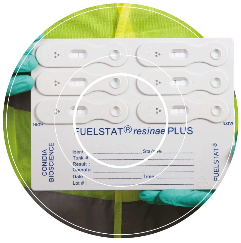 A Fuelstat® immunoassay test kit being held up in preparation for use with marine fuel to test for microbial contamination