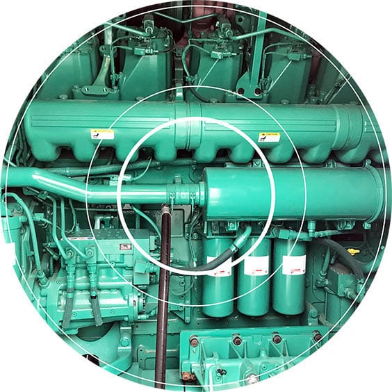 A light-green emergency generator that is in need of diesel fuel testing for microbial contamination.